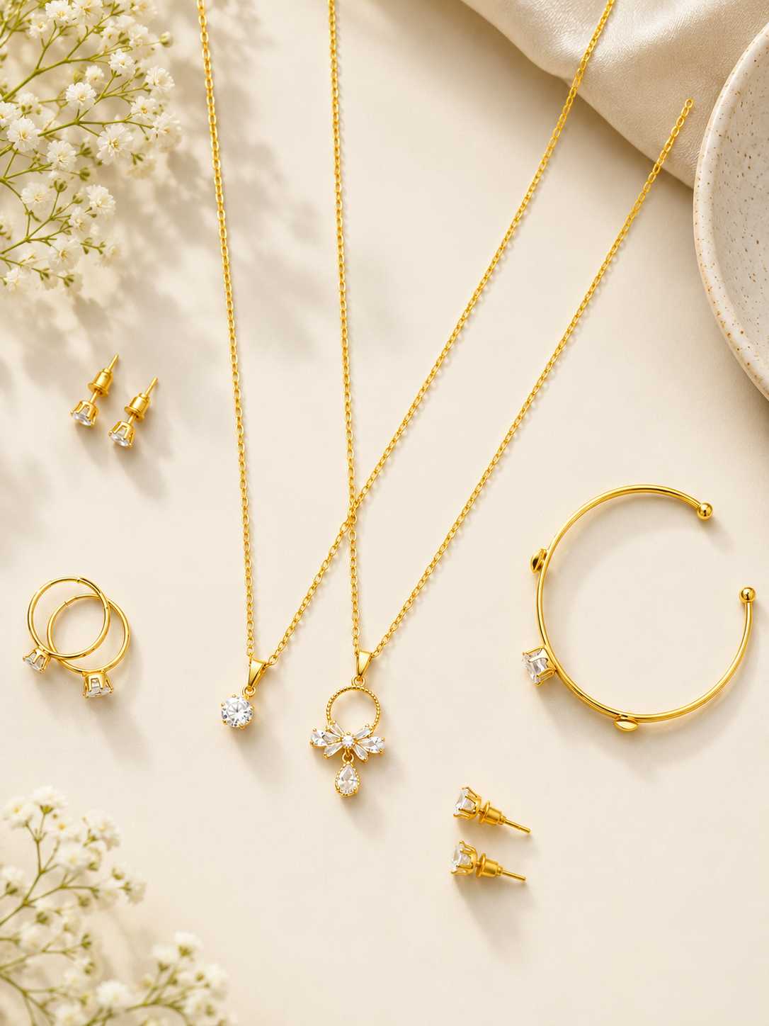 KIDS gold-plated jewelry set featuring crystal pendant necklaces, hoop earrings, stud earrings, and an adjustable bracelet