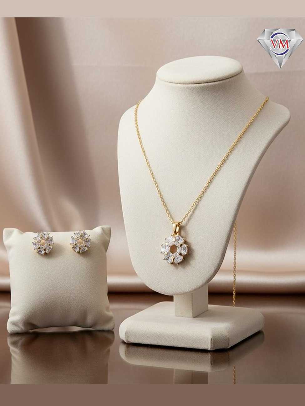 Gold plated jewelry set with a hexagonal open center wreath pendant and earrings made of marquise-cut cubic zirconia.