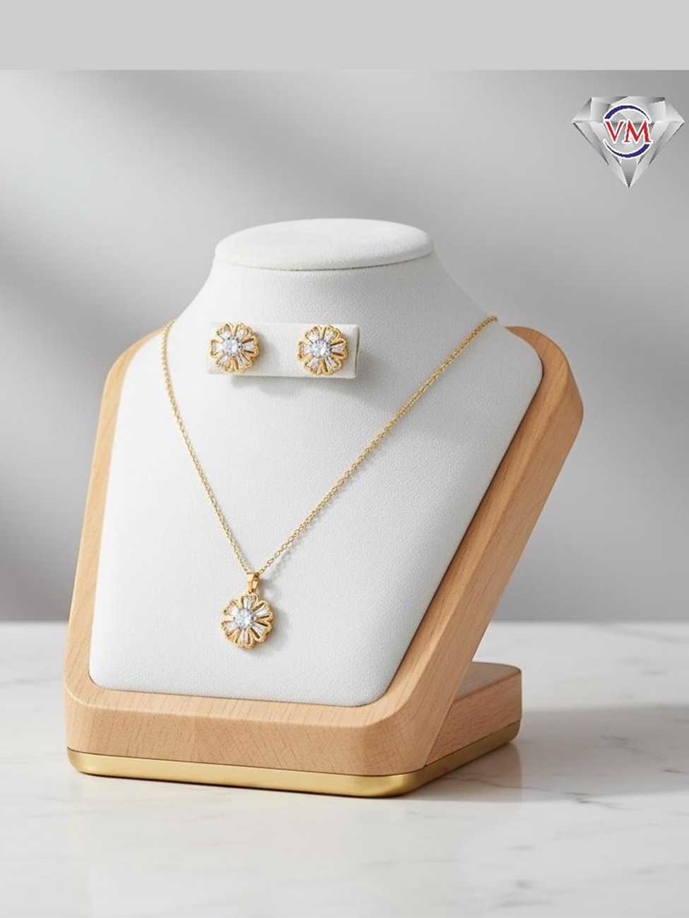 Sunburst inspired gold plated necklace and earrings with a round center stone and baguette cut radial rays