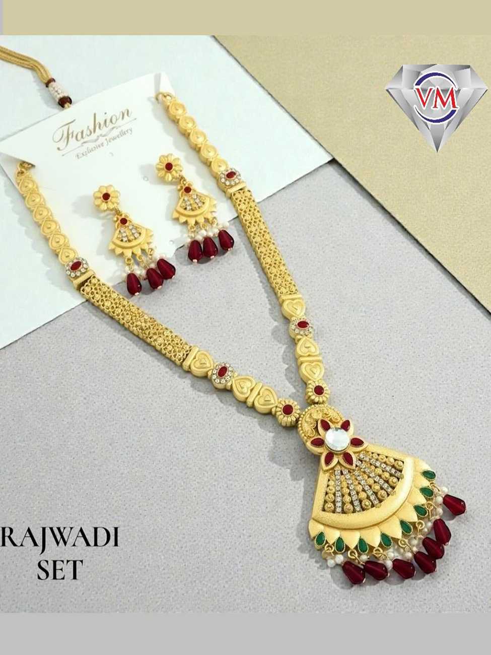 Gold finish Rajwadi necklace set featuring fan drop pendant with kundan stone, green enamel work and ruby bead drops