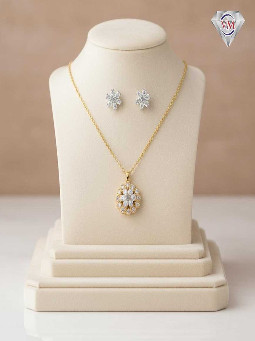 Intricate gold-plated floral pendant and earrings set with concentric circles of brilliant-cut cubic zirconia.