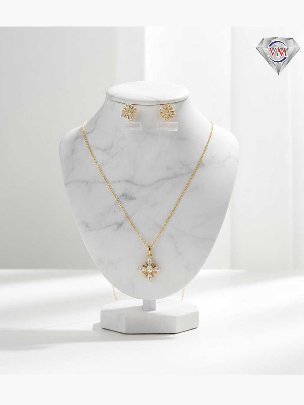 Gold plated celestial star pendant and earrings featuring brilliant round and marquise cut cubic zirconia