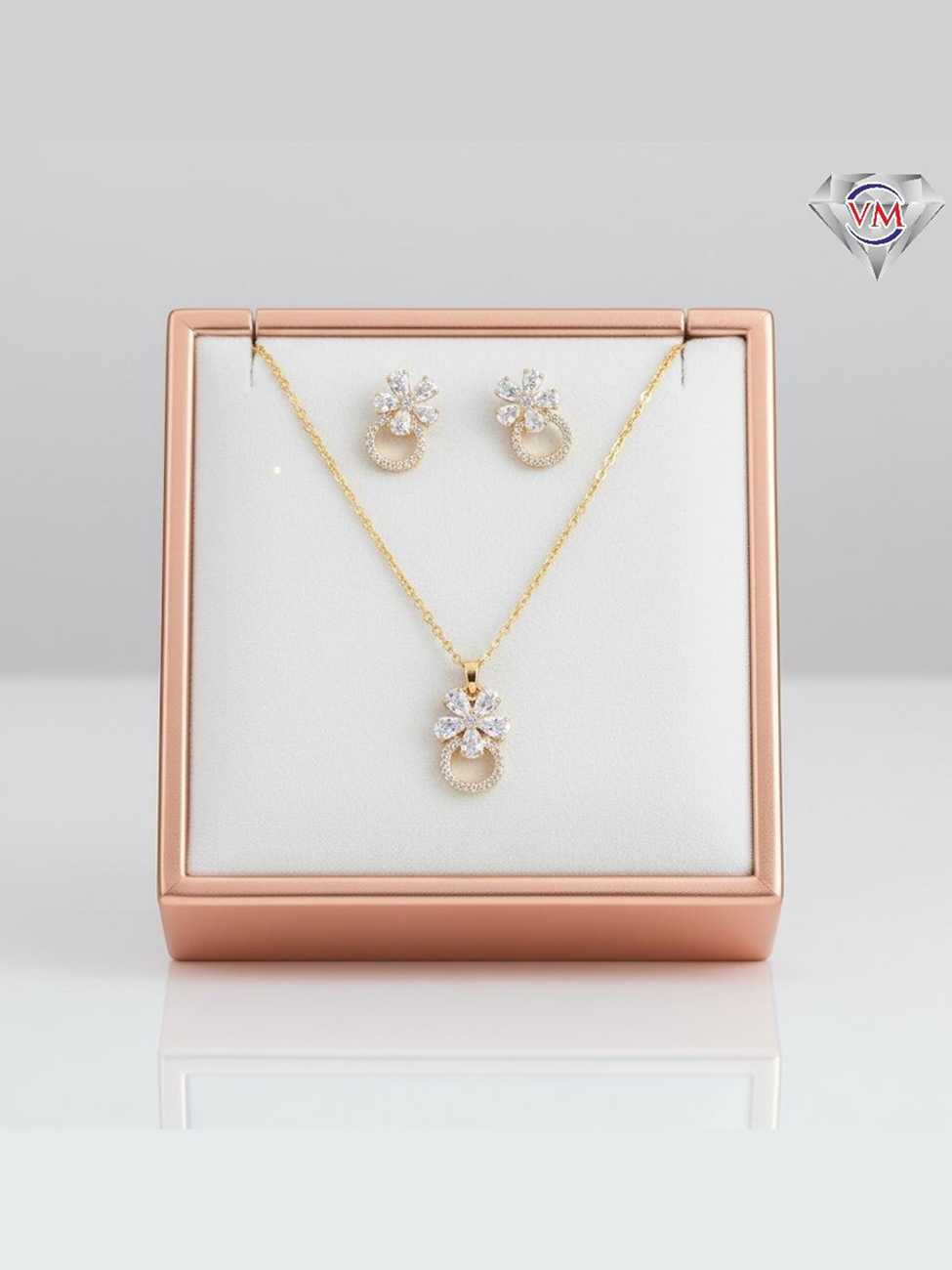 Gold plated floral pendant and earrings with a pav encrusted infinity loop base and marquise flower topper