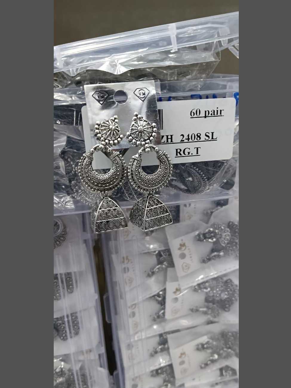 Detailed oxidized silver crescent moon earrings featuring a tiered pyramid-shaped jhumka base.