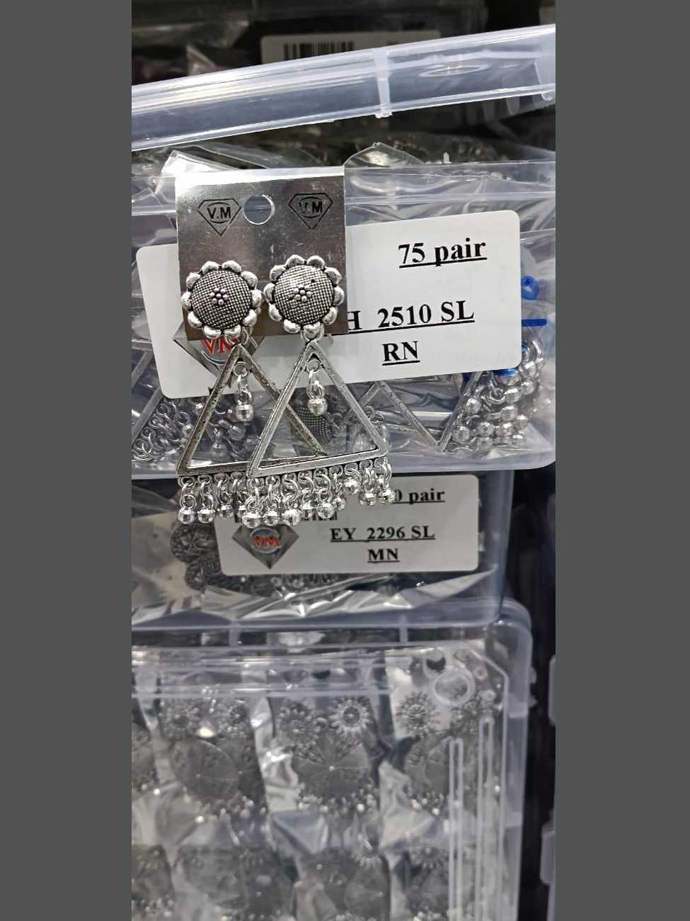 Oxidized silver earrings featuring a sunflower-shaped stud and a minimalist triangular frame with bead tassels