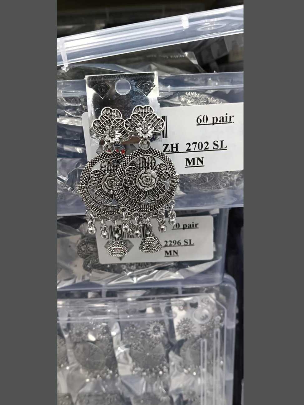 Detailed oxidized silver floral mandala earrings featuring traditional bell-shaped jhumkas and silver bead hangings