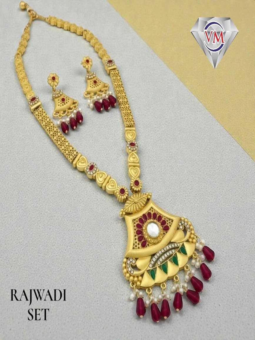Gold plated Rajwadi necklace featuring a central clear stone fan shaped pendant with ruby red and emerald green accents