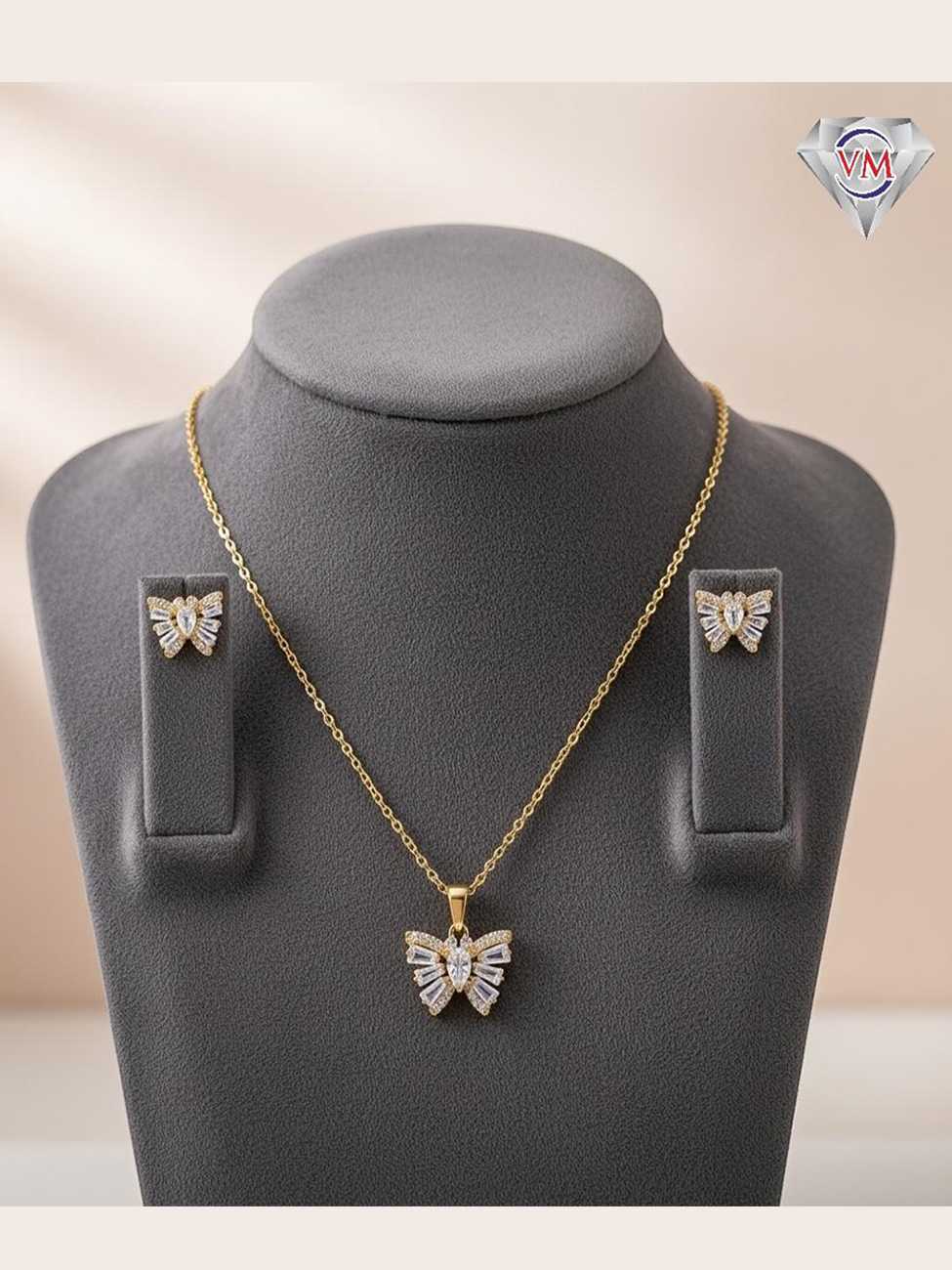 Gold plated butterfly pendant and matching earrings with baguette and marquise cut cubic zirconia crystals