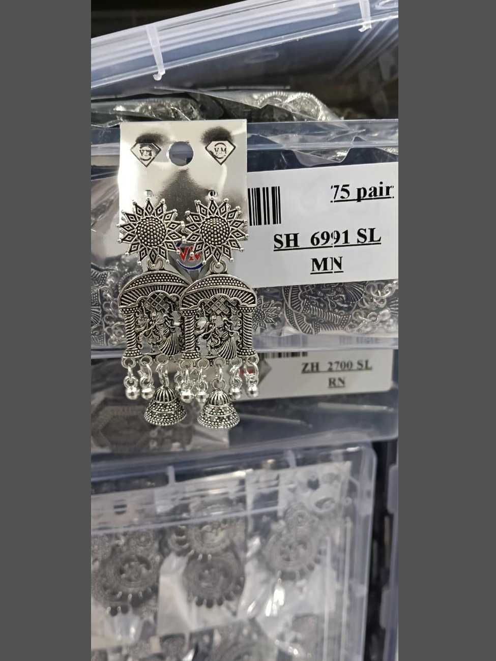 Temple-style oxidized silver earrings with an arched frame and dangling jhumka bells.