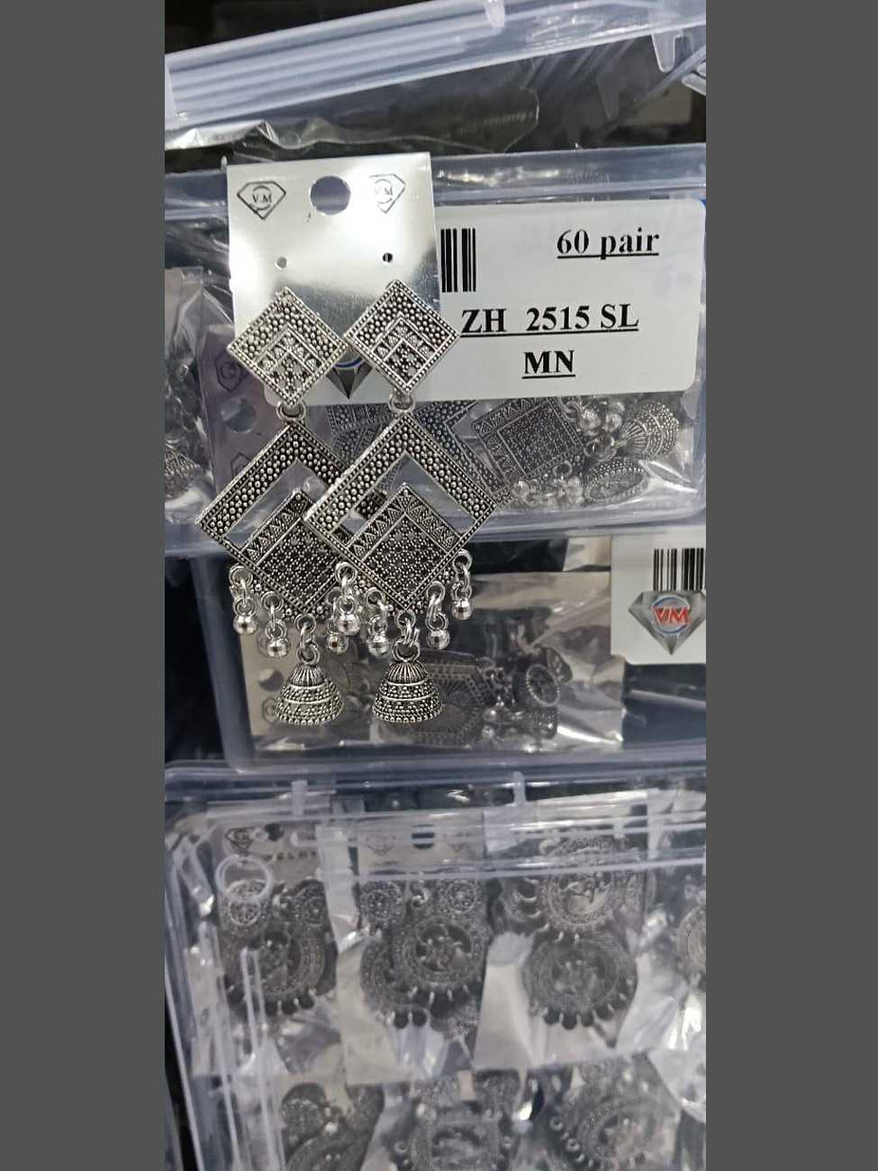 Oxidized silver earrings with nested diamond frames and a central textured jhumka bell