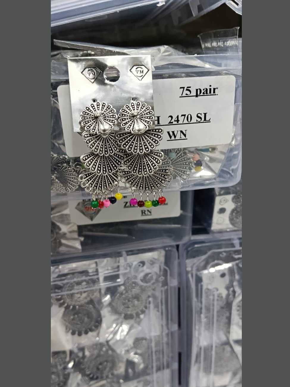 Multi-tiered oxidized silver peacock fan earrings with vibrant, colorful bead accents.