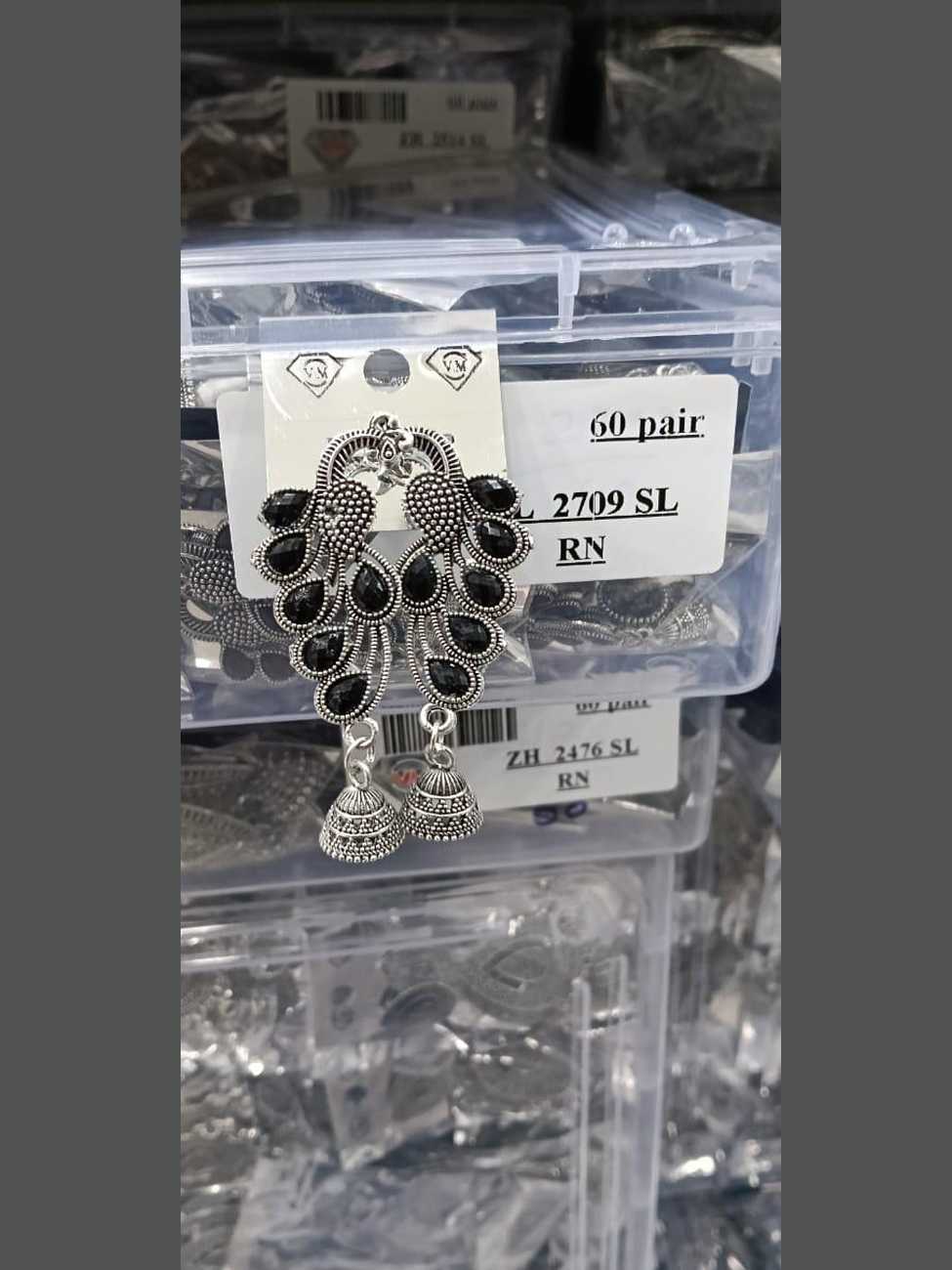 Stunning peacock-themed oxidized silver earrings featuring teardrop black stone inlays and jhumka drops.