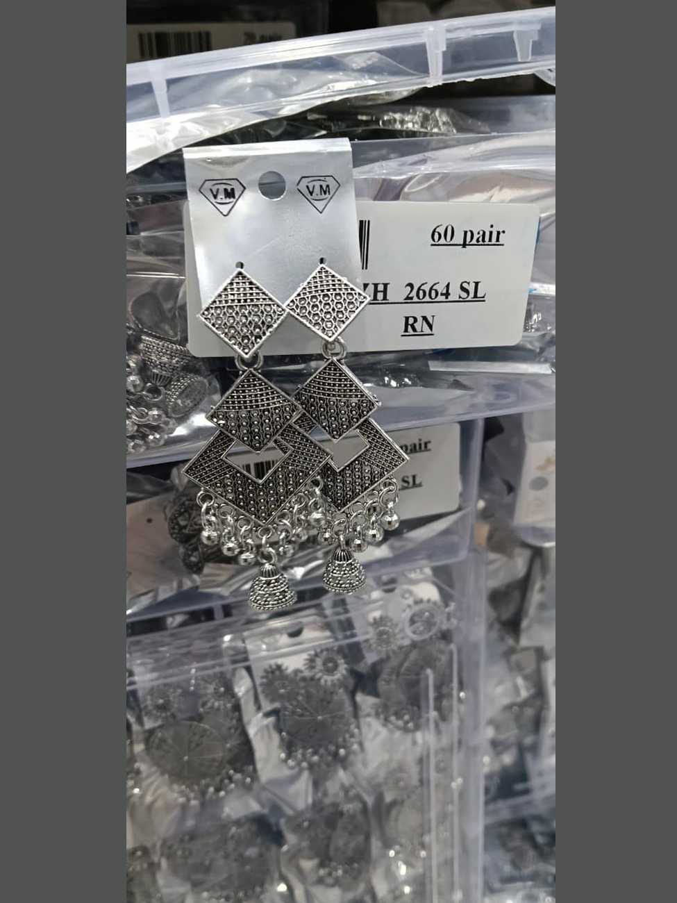 Oxidized silver earrings with three interlocking diamond shapes and tiny jhumka bells.