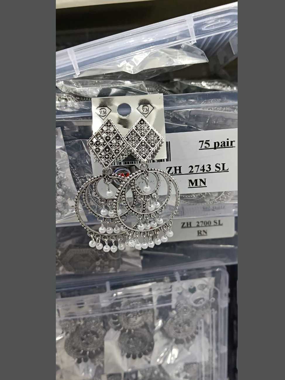 Elegant oxidized silver earrings featuring a diamond-shaped filigree stud and tiered hoops with white pearl bead fringes.