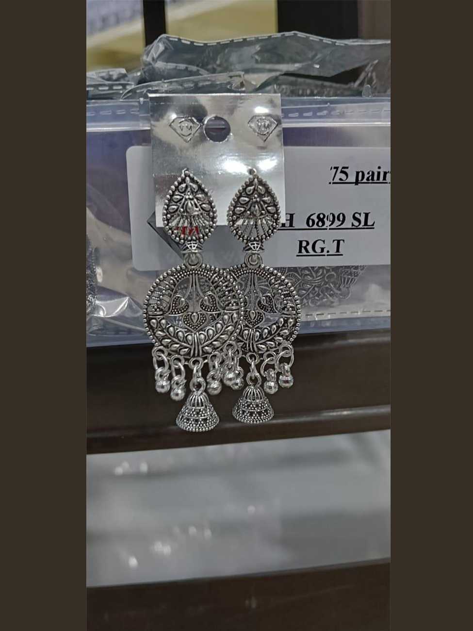 Oxidized silver circular frame earrings with twin peacock motifs and a central jhumka drop