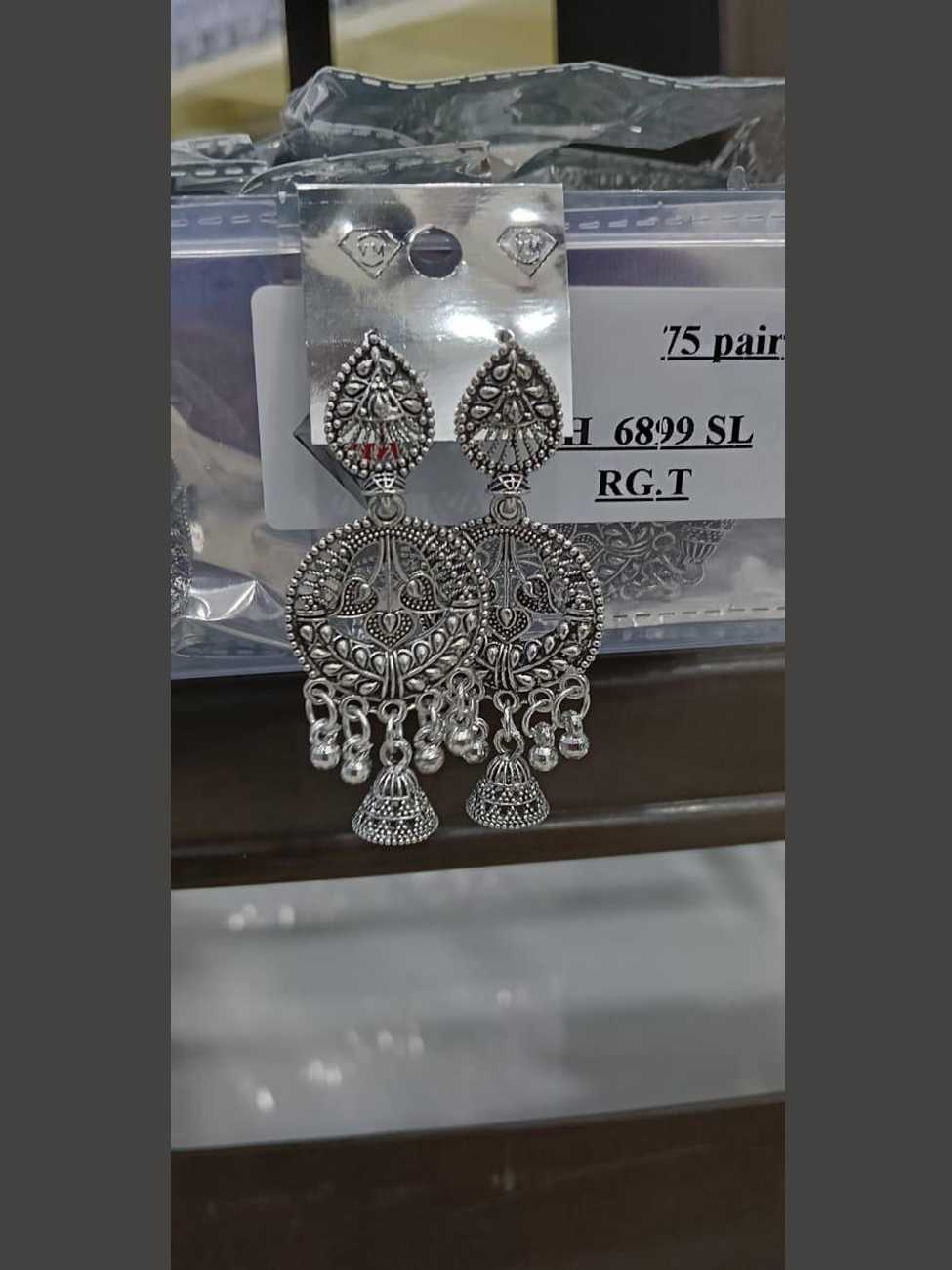 Oxidized silver circular frame earrings with twin peacock motifs and a central jhumka drop