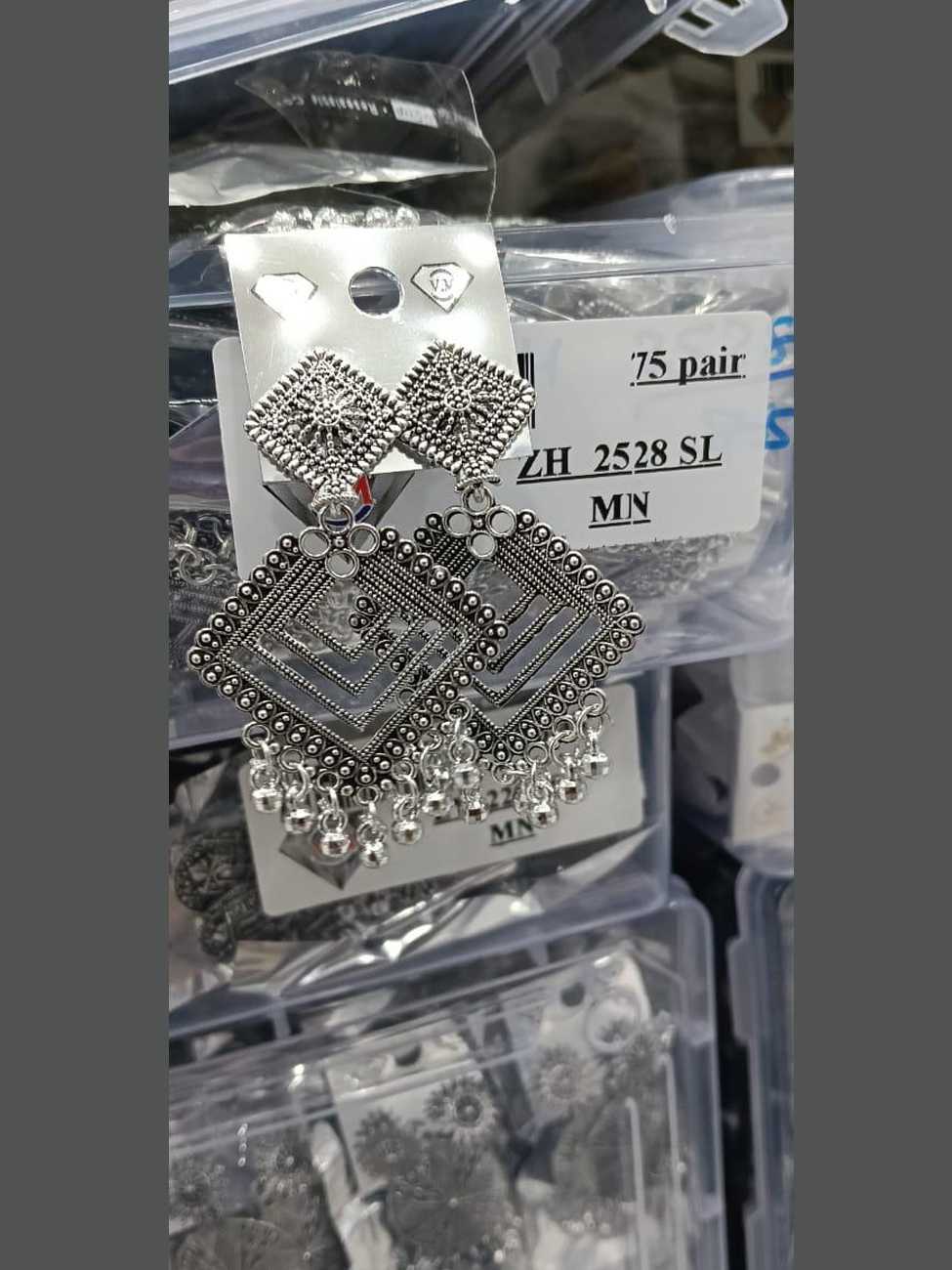 Geometric oxidized silver earrings featuring two interlocking diamond frames and bead drops.