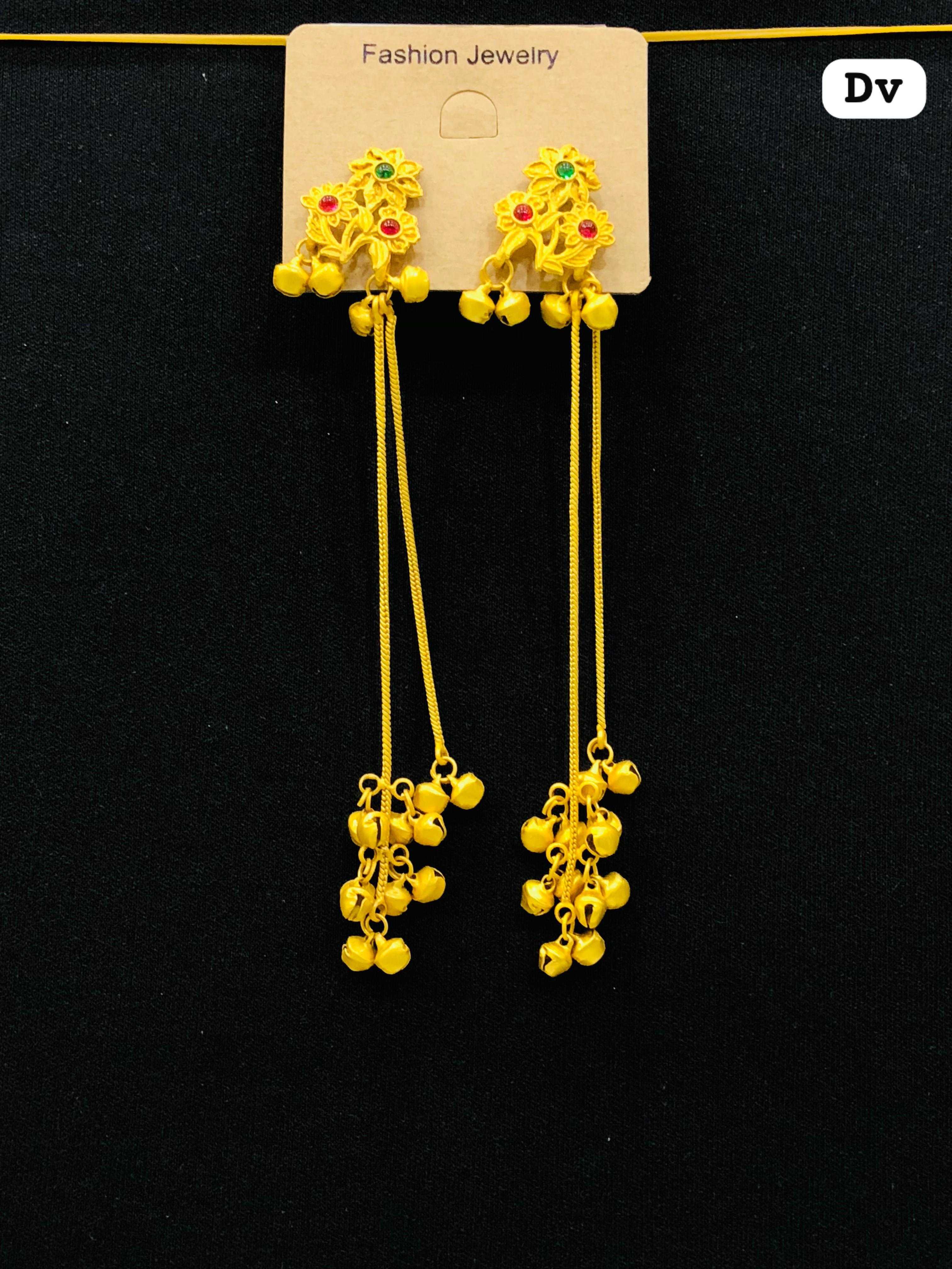 Long matte yellow earrings featuring a three-flower stud design with red and green stone centers and cascading thin chains with bell clusters.