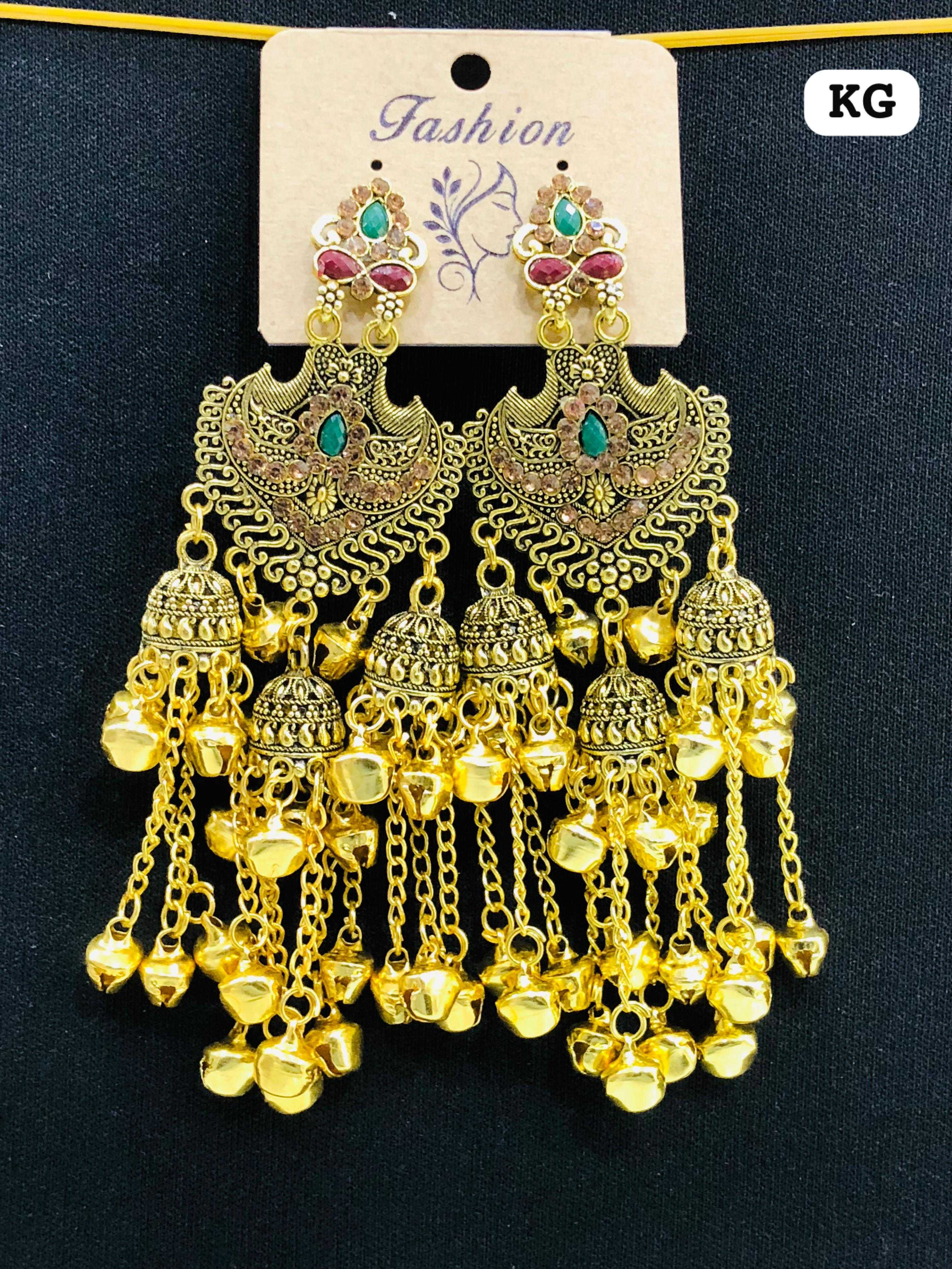 Heavy gold-plated earrings with a large filigree heart-shield, multiple small jhumka domes, and cascading bell chains.
