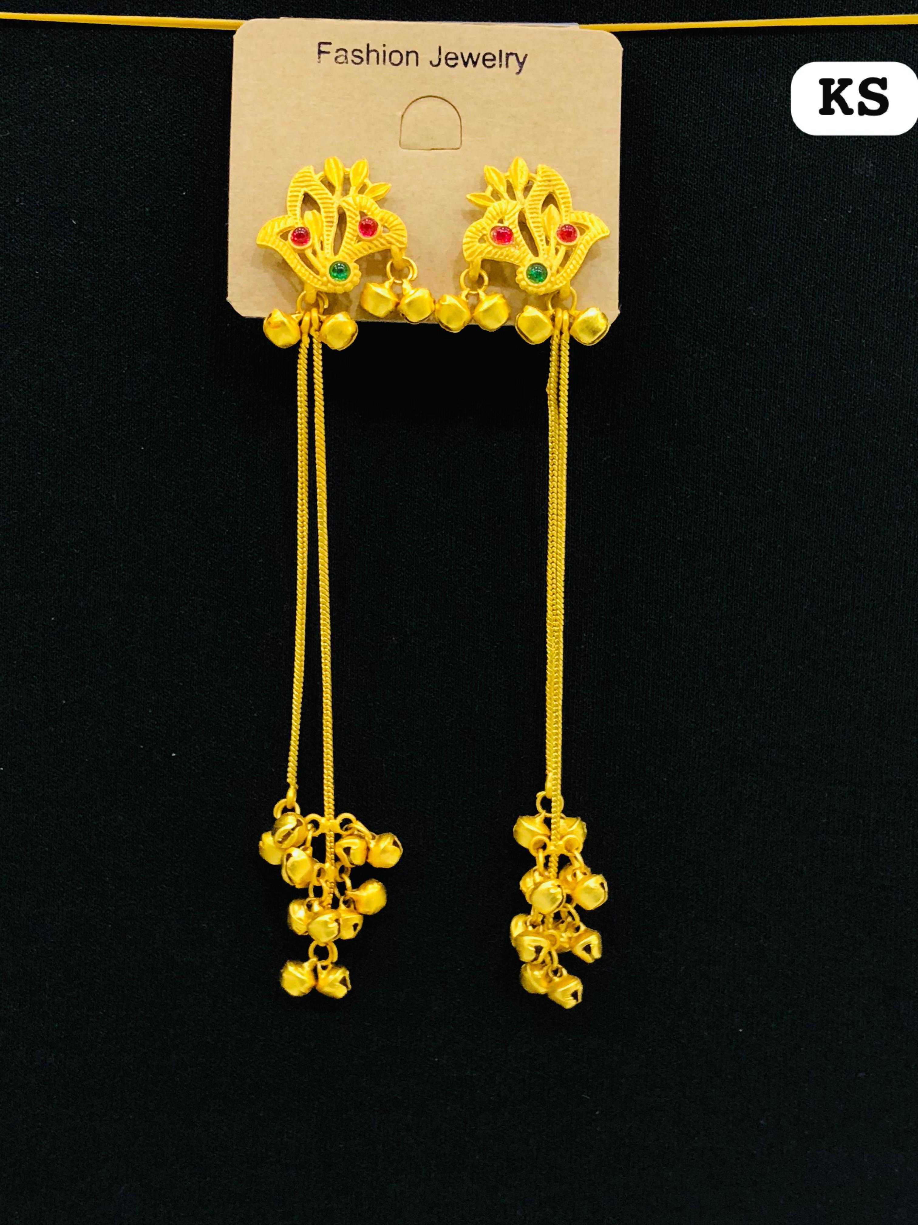 Matte-finish gold earrings with a stylized peacock-leaf stud and two long chains ending in heavy bell clusters.
