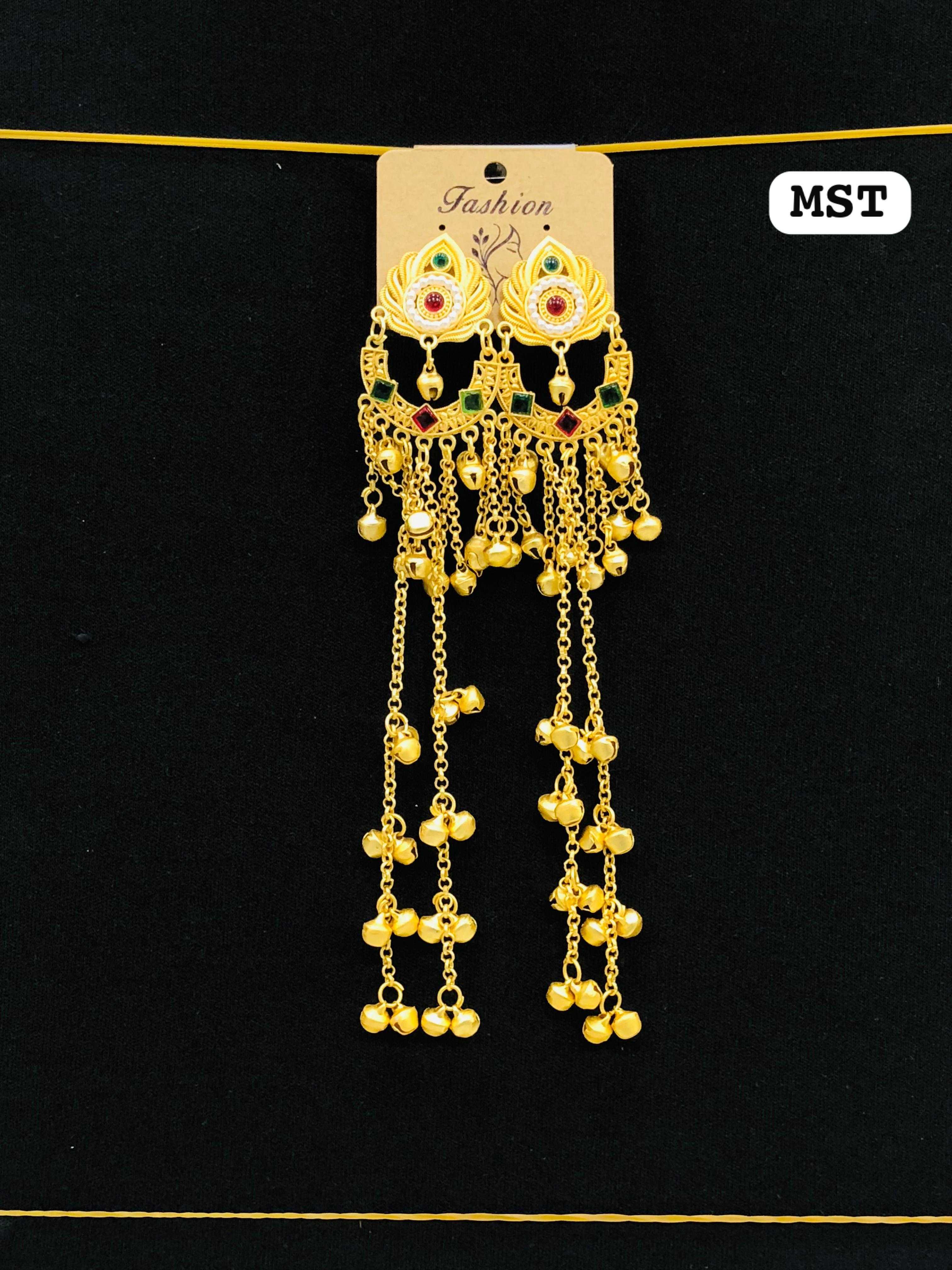 Gold earrings with a lotus-shaped stud, a pearl-accented crescent, and long dangling chains with multiple bell clusters.