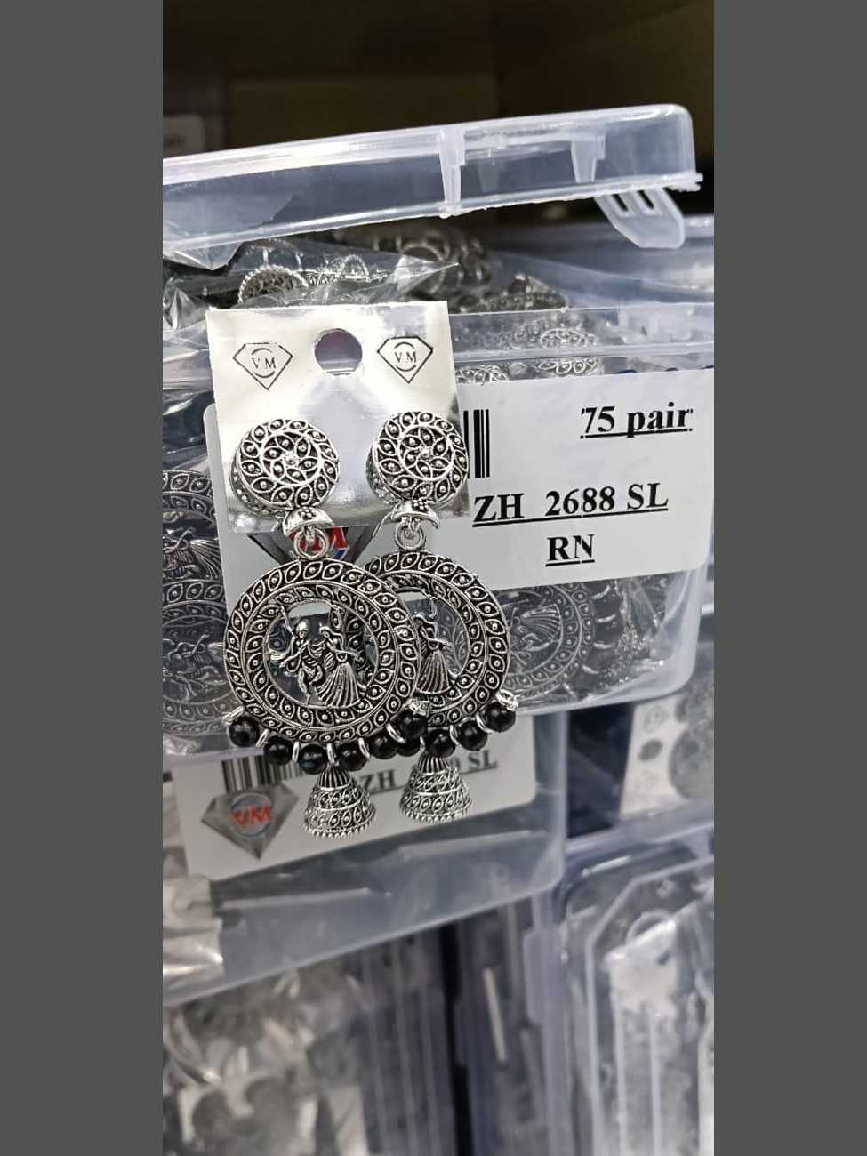 Oxidized silver circular earrings featuring a Radha-Krishna motif and black bead drops.